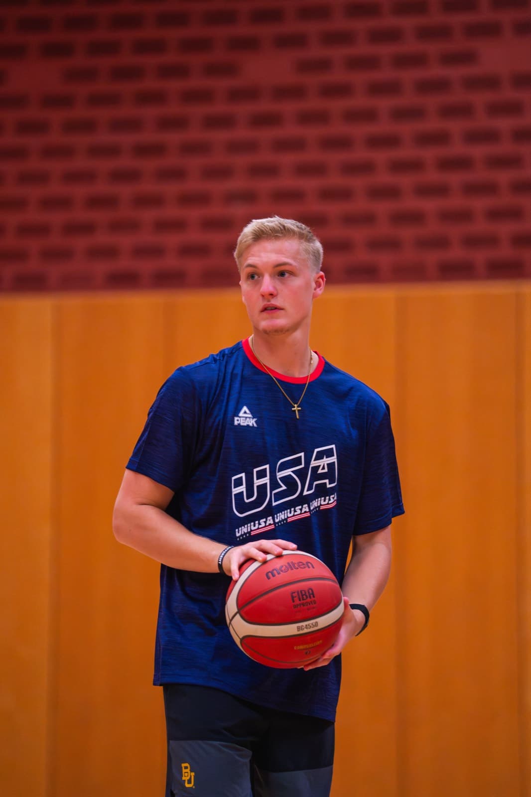 Nolan Mader holding a basketball before a session