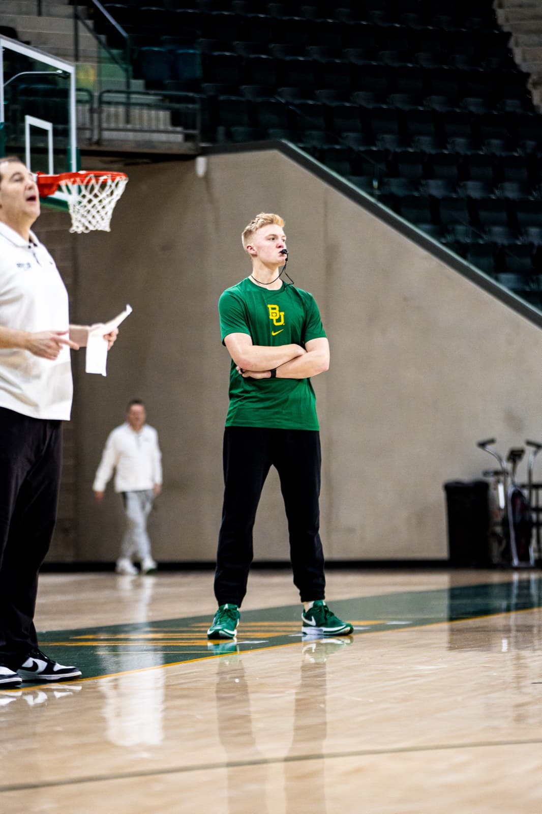 Nolan Mader courtside watching a practice, on staff at Baylor